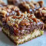 Chewy Decadent Sweet and Chewy Turtle Bars stacked high, featuring toasted pecans and rich caramel swirls.