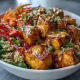 Peanut Tofu Power Bowl features colorful veggies and golden tofu, served warm with a rich, savory peanut drizzle.