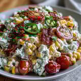 Creamy Corn Salad with Jalapeño in a white bowl, showcasing vibrant colors of fresh vegetables and a tangy dressing.