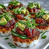 Flaky tuna poke piled high on crunchy fried sushi rice cups, a delightful appetizer.