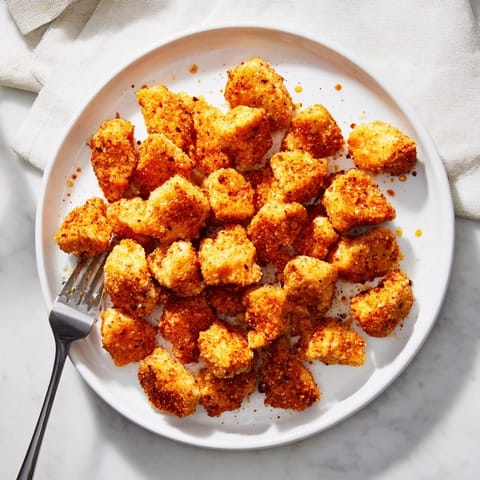 Juicy homemade popcorn chicken bites, a crowd-pleasing appetizer with an irresistible crunch.