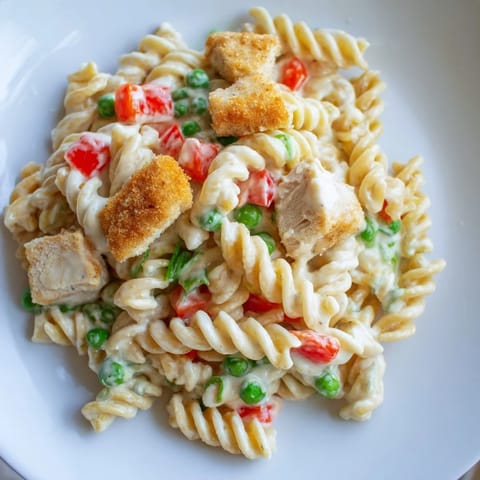 Crispy Chicken Ranch Pasta Salad featuring golden fried chicken bites, creamy ranch dressing, and vibrant red bell peppers served in a bowl.