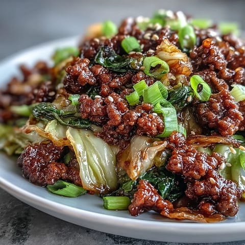 A skillet of Chinese Ground Beef and Cabbage Stir-Fry with saucy, crisp-tender vegetables and savory ground beef.