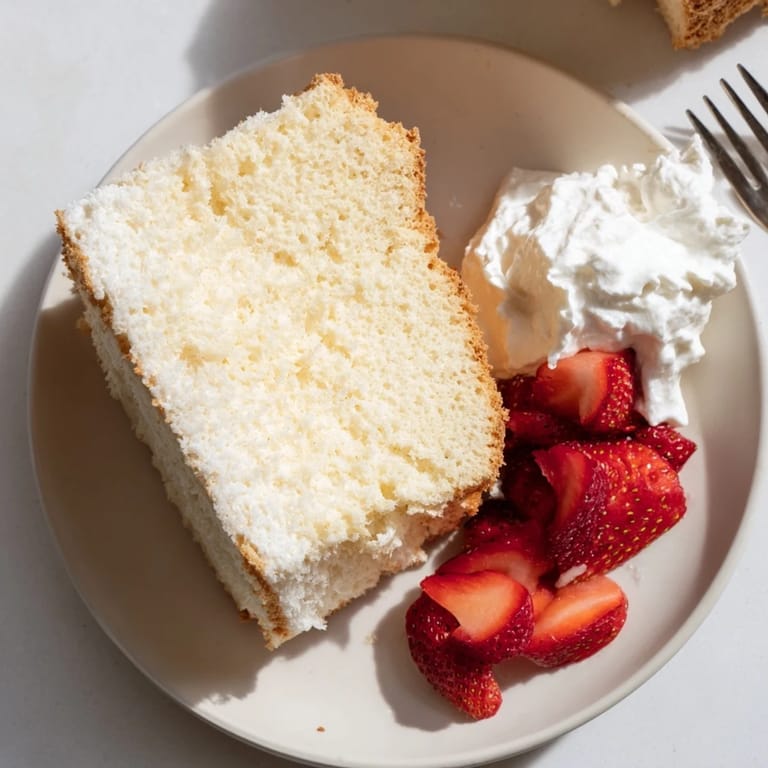 Beautifully baked Angel Food Cake, a fluffy, white dessert creation.
