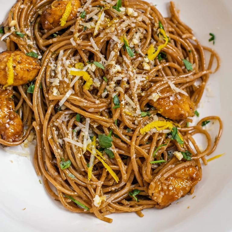 Seared chicken strips rest atop warm Brown Butter Lemon Chicken Pasta, finished with grated Parmesan and herbs.