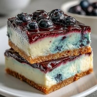 Creamy No-Bake Lemon Blueberry Cheesecake Bars with vibrant swirls.